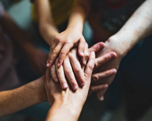 multi generation family holding hands.